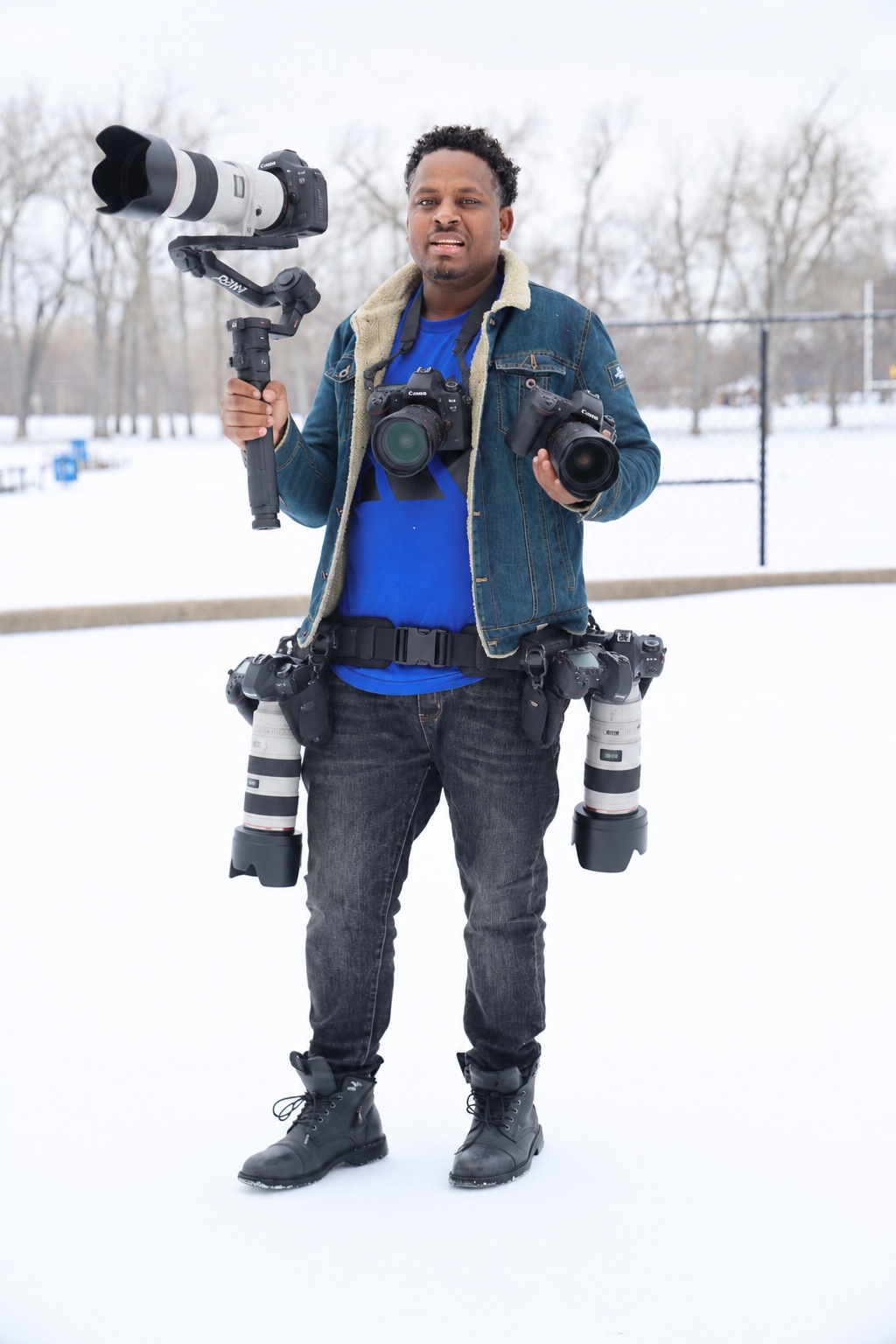 MG STUDIO cameraman holding a gimbal, cameras and long lenses